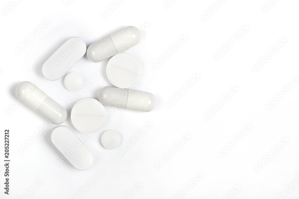 round and oval white pills and capsules on a white background round and oval white pills and capsules on a white background