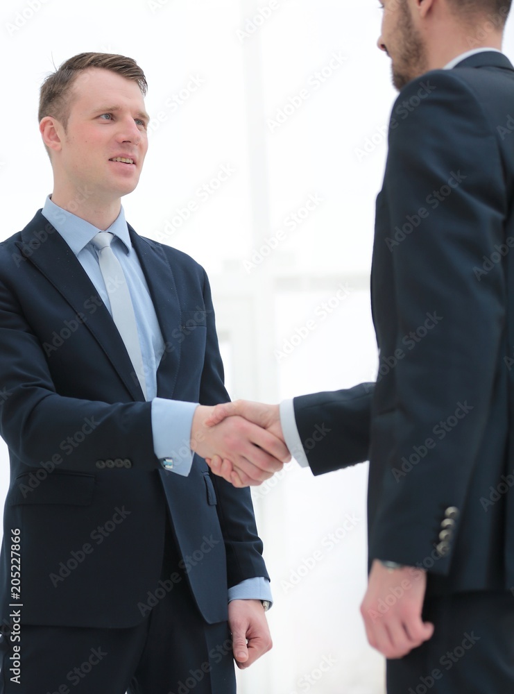 handshake financial partners in the corridor of the office handshake financial partners in the corridor of the office
