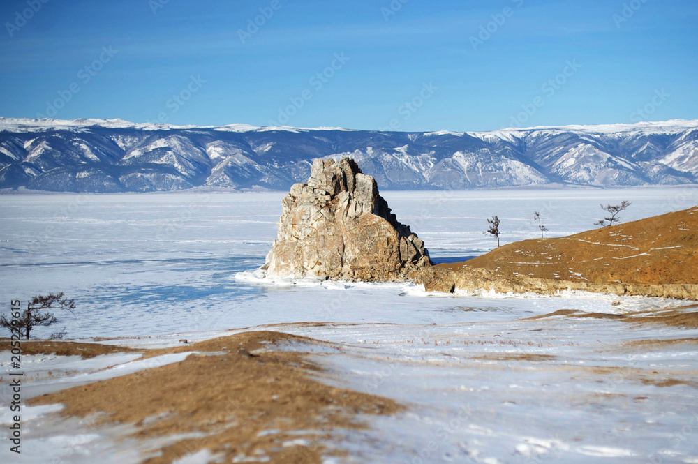 Shamanka rock in winter. Olkhon island, Baikal lake, Siberia, Russia.