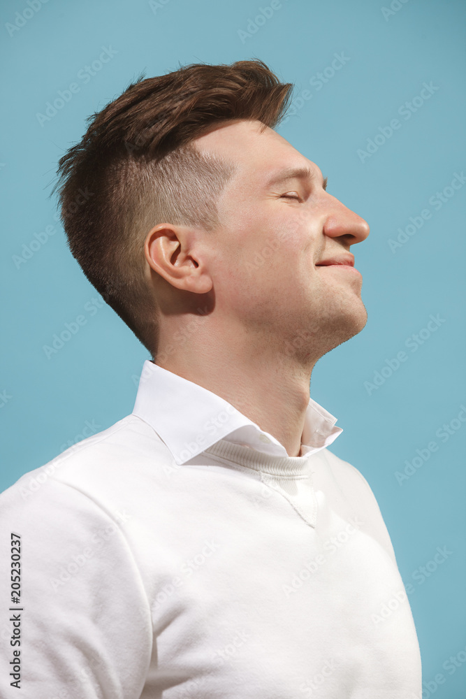 Fototapeta premium The happy business man standing and smiling against studio background.