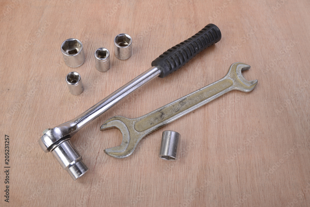 various professional metalwork tools on a background of beech wood various professional metalwork tools on a background of beech wood