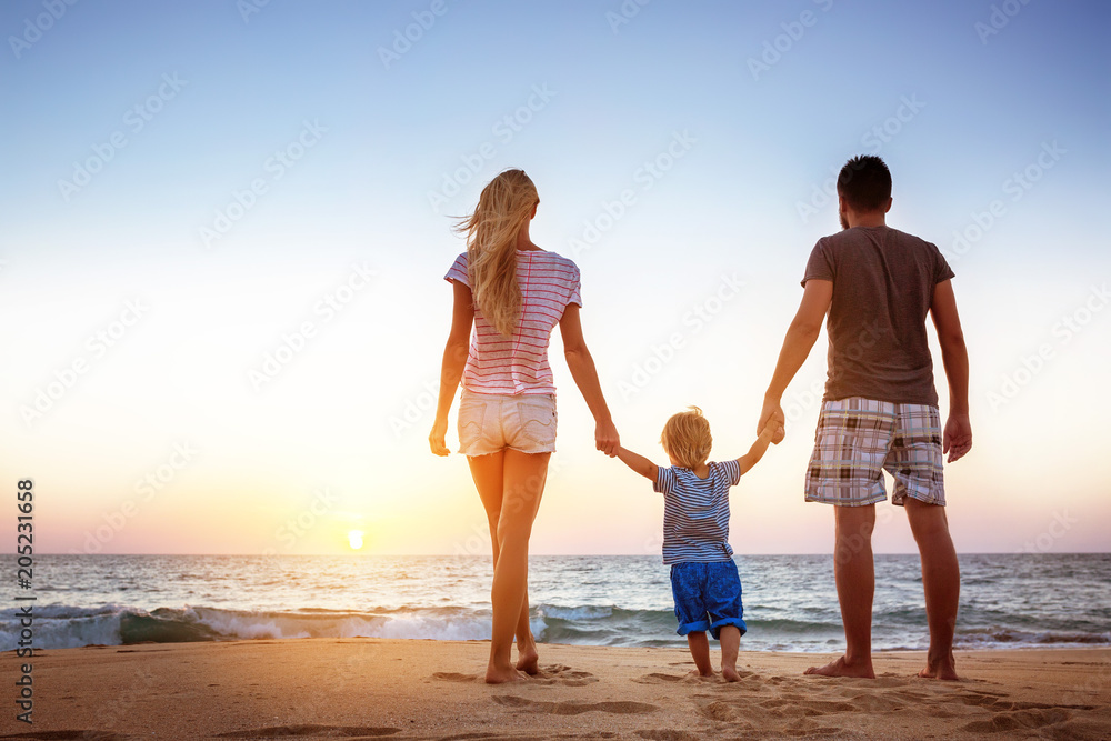 Happy family beach holidays vacations sunset concept Happy family beach holidays vacations sunset concept