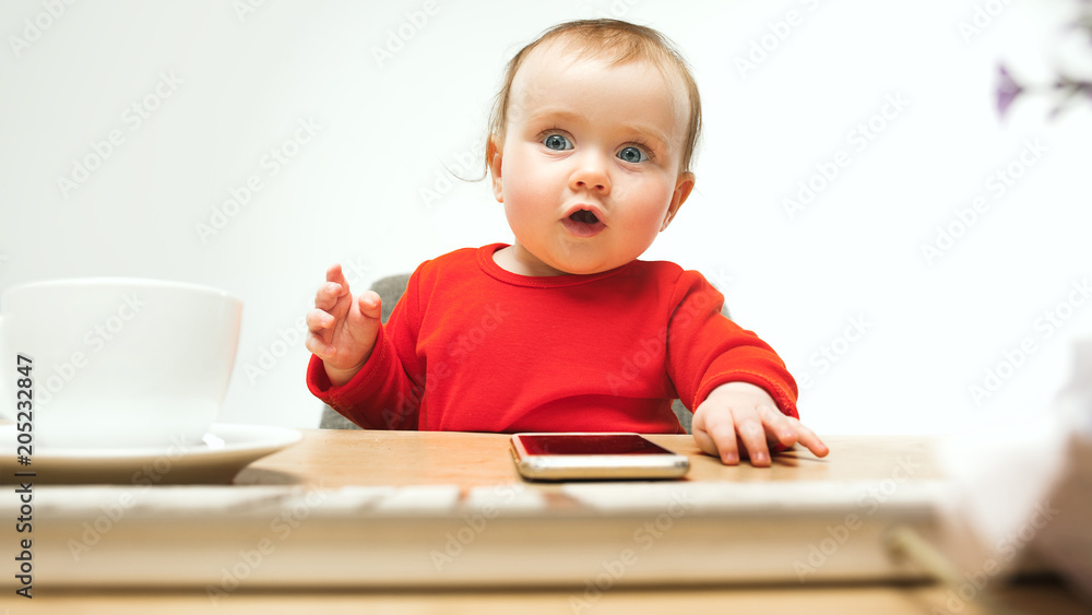 Happy child baby girl toddler sitting with keyboard of computer isolated on a white background Happy child baby girl toddler sitting with keyboard of computer isolated on a white background