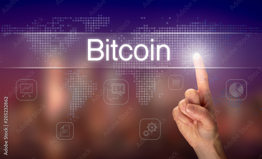 A hand selecting a Bitcoin business concept on a clear screen with a colorful blurred background.