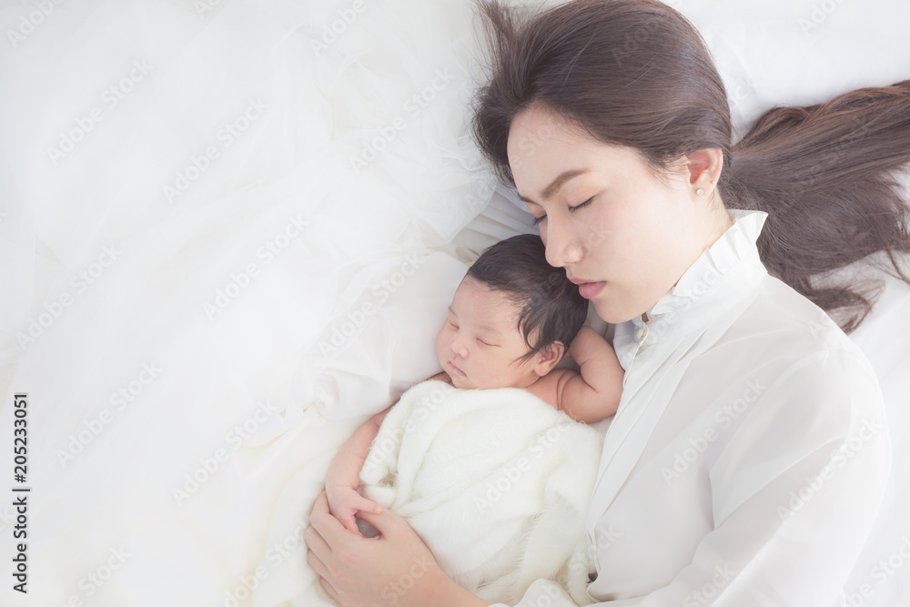 happy mother with baby in bed happy mother with baby in bed