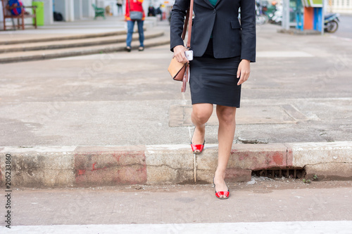 Business woman walking across the crosswalk © Chayanin Wongpracha