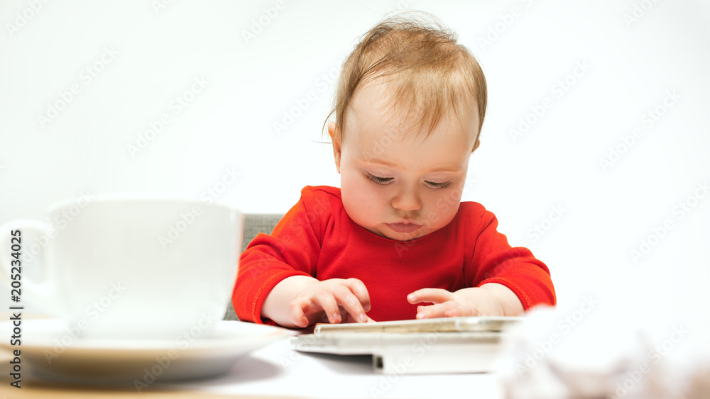 Happy child baby girl toddler sitting with keyboard of computer isolated on a white background Happy child baby girl toddler sitting with keyboard of computer isolated on a white background