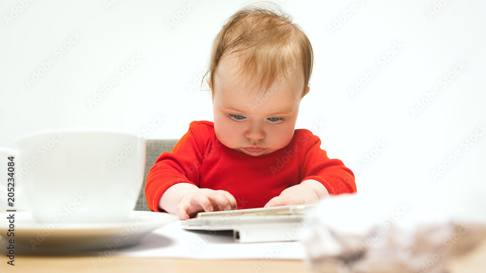 Happy child baby girl toddler sitting with keyboard of computer isolated on a white background Happy child baby girl toddler sitting with keyboard of computer isolated on a white background