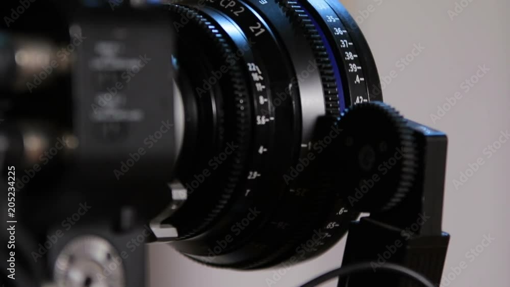 Professional camcorder turns from side to front with working gear of radio-focus close-up (1080p, 25fps) Professional camcorder turns from side to front with working gear of radio-focus close-up (1080p, 25fps)
