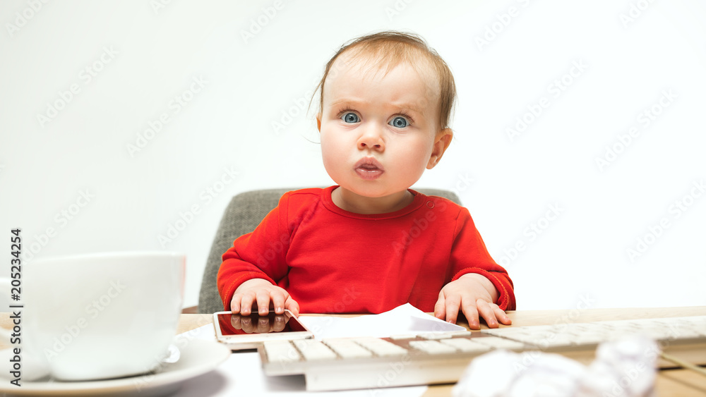 Happy child baby girl toddler sitting with keyboard of computer isolated on a white background Happy child baby girl toddler sitting with keyboard of computer isolated on a white background