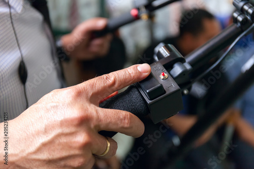 Close-up of working camera of man hand  operator at work.