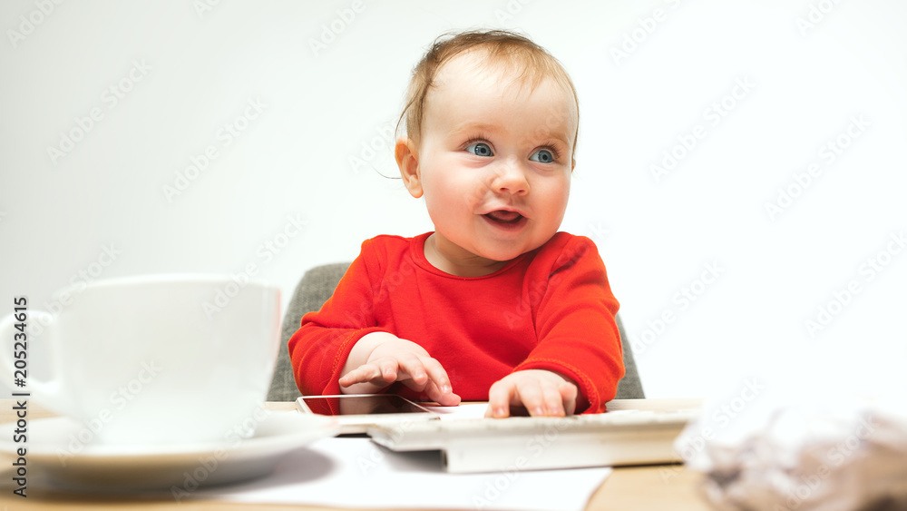 Happy child baby girl toddler sitting with keyboard of computer isolated on a white background Happy child baby girl toddler sitting with keyboard of computer isolated on a white background