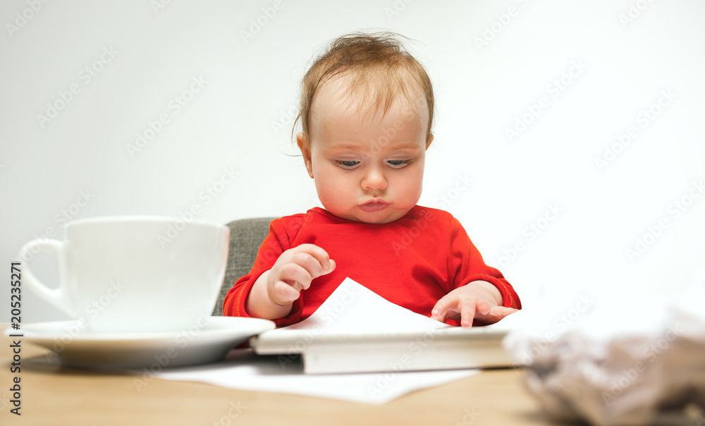 Happy child baby girl toddler sitting with keyboard of computer isolated on a white background Happy child baby girl toddler sitting with keyboard of computer isolated on a white background