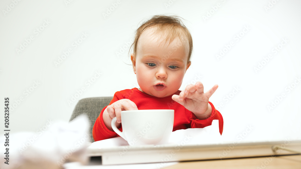 Happy child baby girl toddler sitting with keyboard of computer isolated on a white background Happy child baby girl toddler sitting with keyboard of computer isolated on a white background