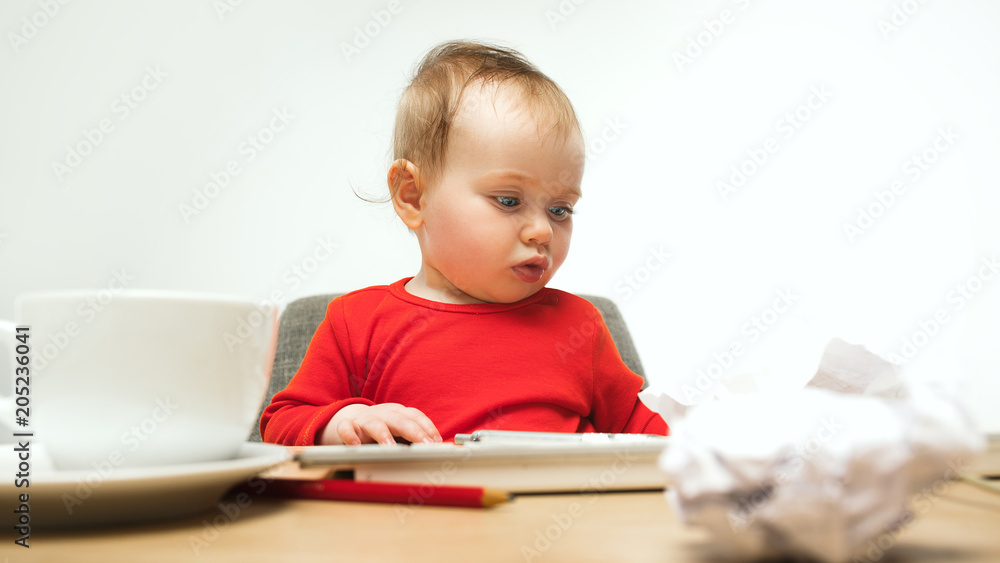 Happy child baby girl toddler sitting with keyboard of computer isolated on a white background Happy child baby girl toddler sitting with keyboard of computer isolated on a white background