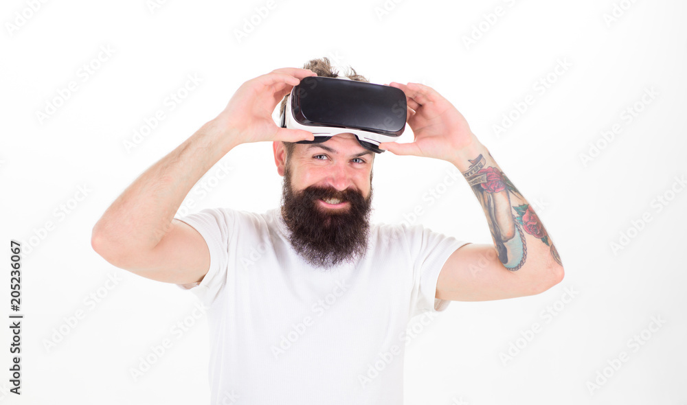 Man with beard and mustache holds VR glasses, white background. VR technology concept. Guy with VR glasses or head mounted display. Hipster on smiling face use modern technologies for entertainment Man with beard and mustache holds VR glasses, white background. VR technology concept. Guy with VR glasses or head mounted display. Hipster on smiling face use modern technologies for entertainment