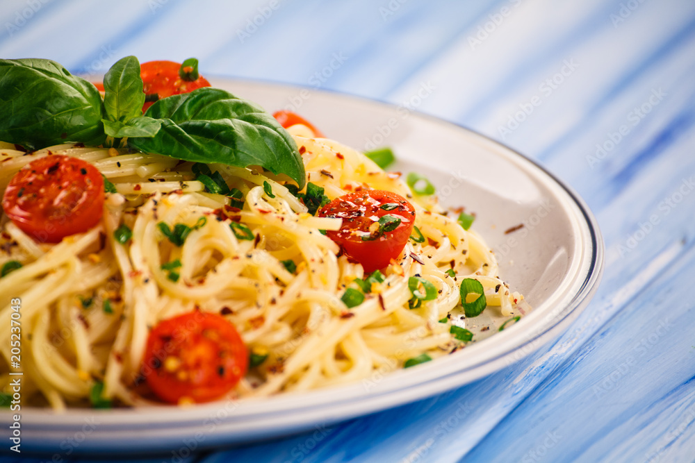 Pasta with vegetables on wooden table Pasta with vegetables on wooden table