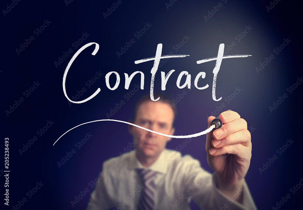 A businessman writing a Contract concept with a white pen on a clear screen. A businessman writing a Contract concept with a white pen on a clear screen.