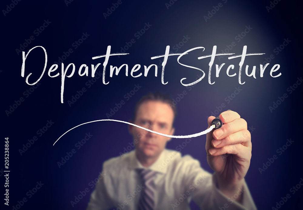 A businessman writing a Department Structure concept with a white pen on a clear screen. A businessman writing a Department Structure concept with a white pen on a clear screen.