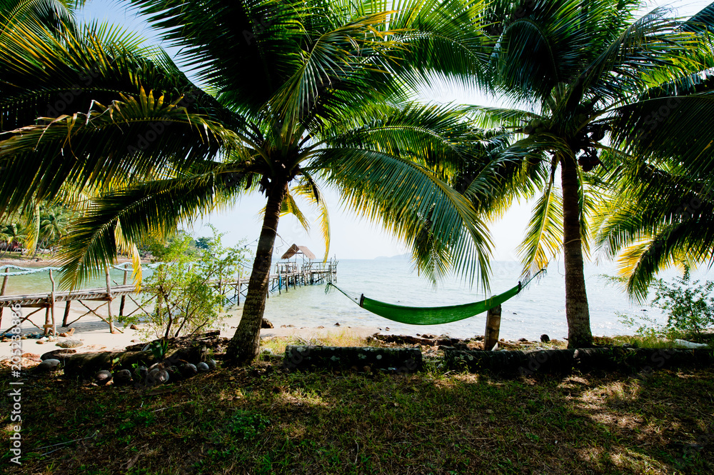 A hammock between palm trees on the beach of Koh Chang, Thailand. A hammock between palm trees on the beach of Koh Chang, Thailand.