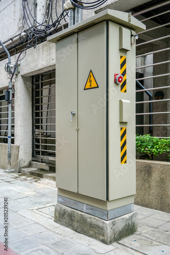 electrical cabinet with warning signs at a street