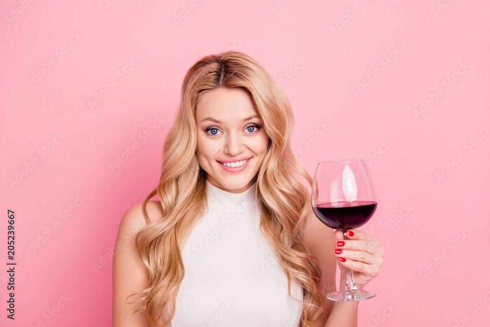 Portrait of foolish cheerful girlfriend having glass with dry semi-sweet red wine in hand looking at camera isolated on pink background Portrait of foolish cheerful girlfriend having glass with dry semi-sweet red wine in hand looking at camera isolated on pink background