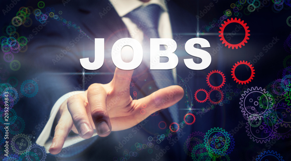 A businessman pressing a Jobs business concept on a graphical display of cogs A businessman pressing a Jobs business concept on a graphical display of cogs