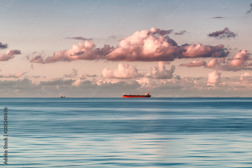 Cloudy sunset on the Baltic sea. With ships on the horizon Cloudy sunset on the Baltic sea. With ships on the horizon
