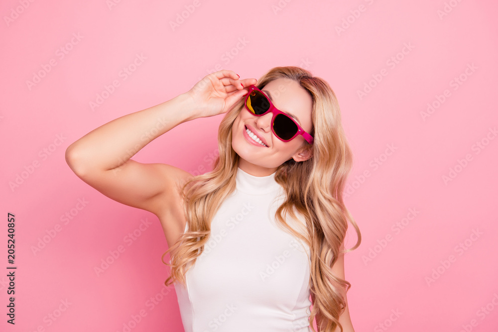 Portrait of lovely positive stylish girlfriend with beaming smile, fashionable successful confident chick in summer glasses holding eyelet with hand isolated on pink background Portrait of lovely positive stylish girlfriend with beaming smile, fashionable successful confident chick in summer glasses holding eyelet with hand isolated on pink background