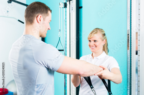 Patient at the physiotherapy doing physical exercises with Bowden cable  photo