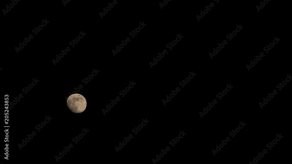 The moon is moving in the dark night sky. Time lapse The moon is moving in the dark night sky. Time lapse