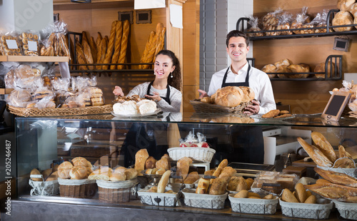 Couple selling pastry and loaves
