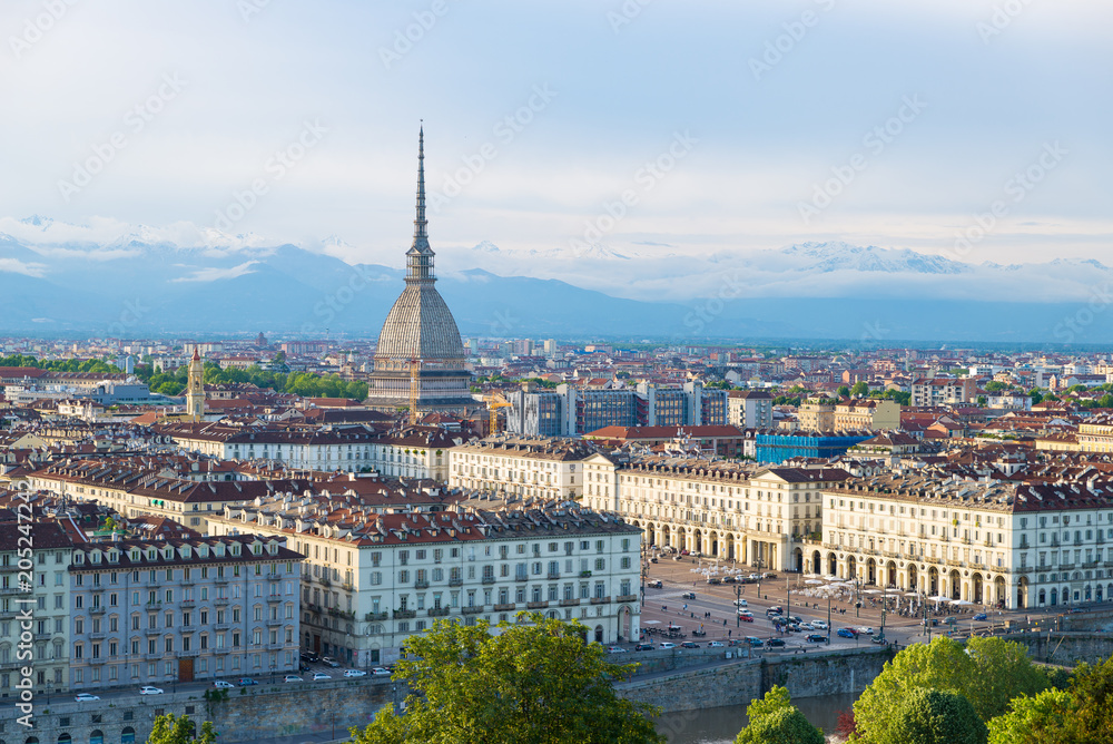 Turin skyline at sunset, Torino, Italy, panorama cityscape with the Mole Antonelliana over the city. Scenic colorful light and dramatic sky.