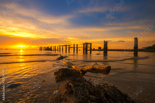 Tableau sur toile The beautiful twilight with the old bridge and the timber on the beach at Chonburi province, Thailand