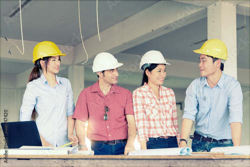 Group of Multiethnic engineers meeting about their project in construction site. Engineer present to his team about their project. Engineer and Construction concept.