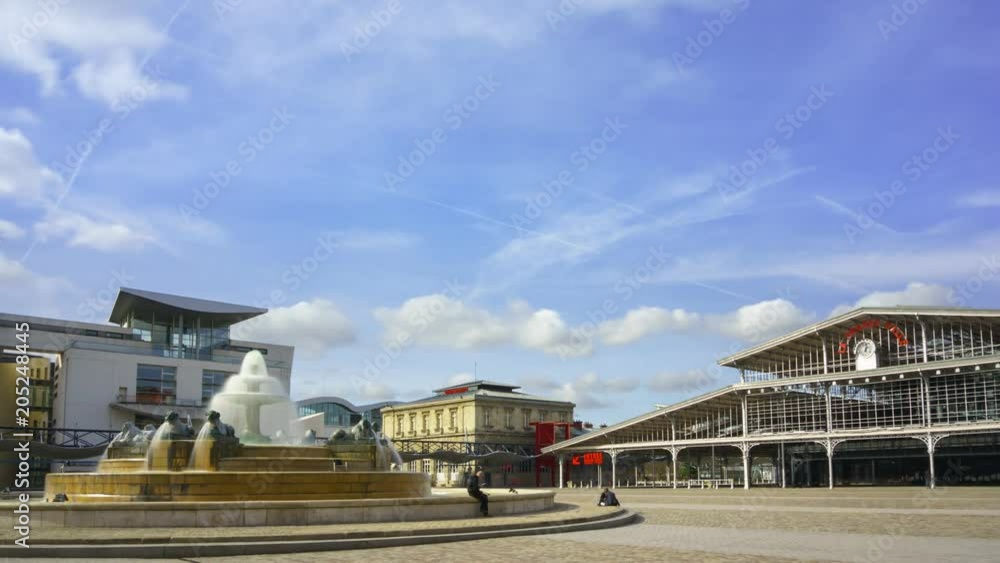 Timelapse of La Grande Halle and a fountain on Parc de la Villette in Paris Timelapse of La Grande Halle and a fountain on Parc de la Villette in Paris