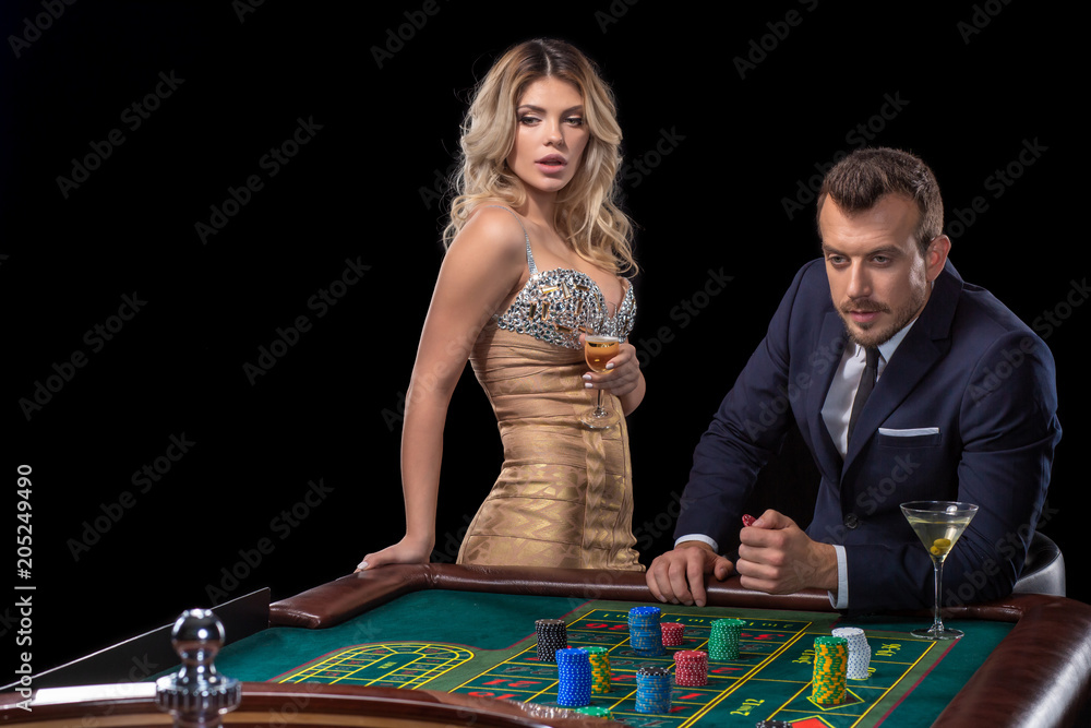 Couple gambling at roulette table in casino Couple gambling at roulette table in casino