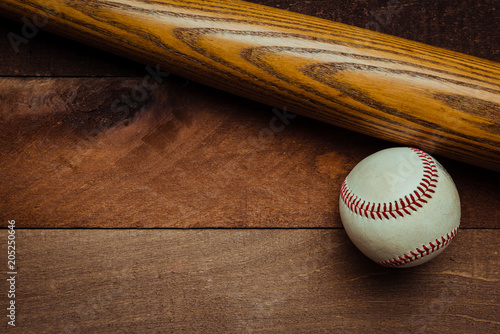 Canvas Print A group of vintage baseball equipment, bats baseballs on wooden background