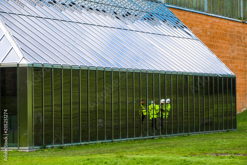 Reflection of  architects and surveyors in the windows of the building housing The Burrell Collection during its renovation.  photo