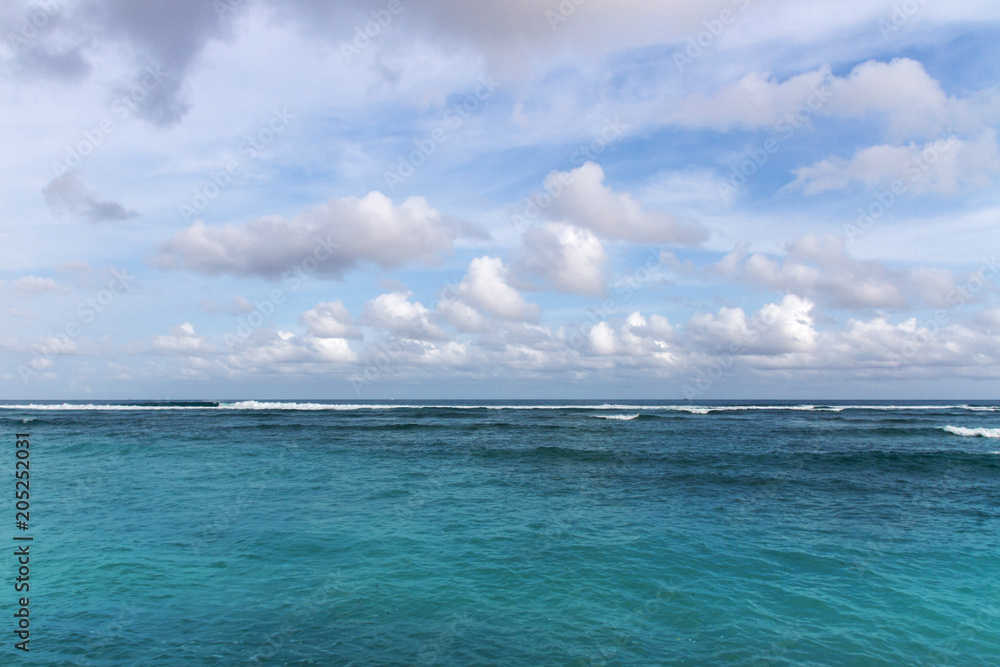 Colorful ocean seascape with azure water and blu sky with clouds