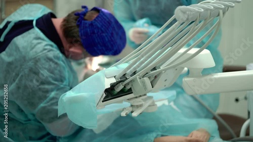 Unrecognizable dentist working with patient photo