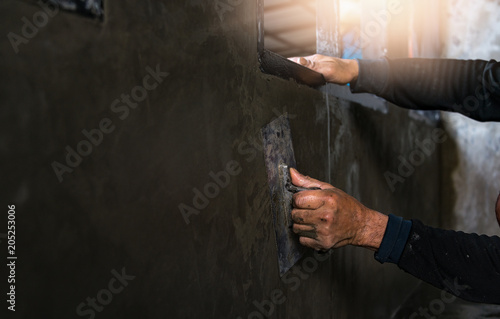 blue collar workers working in factory,Worker builds a brick wall.