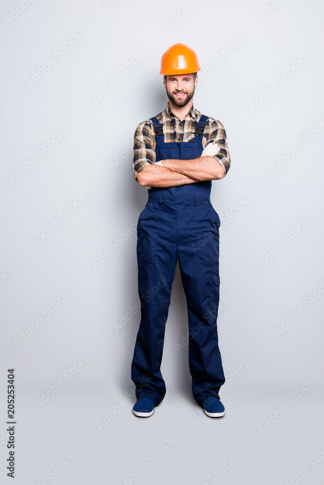 Full size fullbody portrait of cheerful joyful repairer in shirt and overall, having his arms crossed, looking at camera, isolated on grey background Full size fullbody portrait of cheerful joyful repairer in shirt and overall, having his arms crossed, looking at camera, isolated on grey background