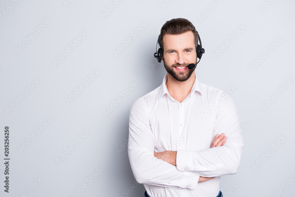Portrait with copyspace, empty place for advertisement of stylish cheerful operator with headset with microphone on head and crossed arms isolated on grey background Portrait with copyspace, empty place for advertisement of stylish cheerful operator with headset with microphone on head and crossed arms isolated on grey background