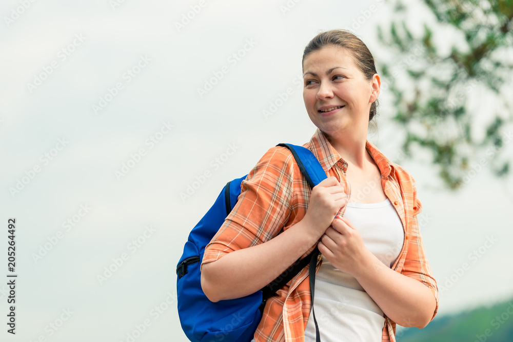 portrait of a tourist with a backpack on the nature in a hike portrait of a tourist with a backpack on the nature in a hike