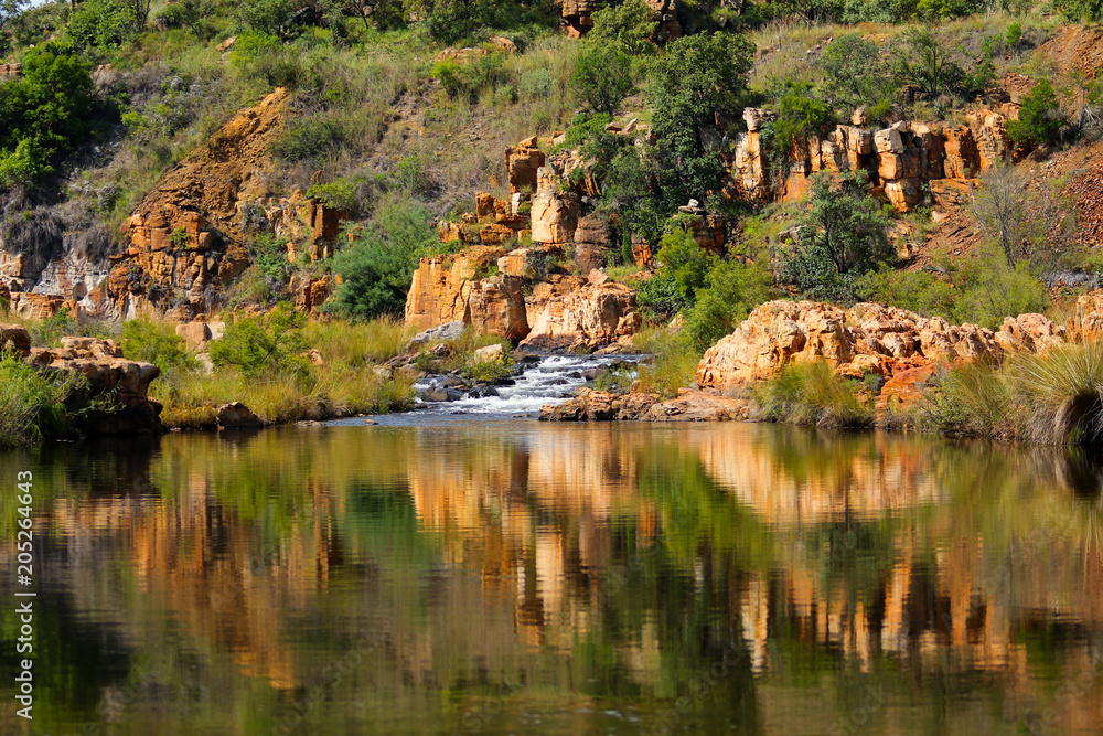Reflection of rocks in the river at Bourke's Luck Potholes geological formation in the Blyde River Canyon area, Mpumalanga district, South Africa Reflection of rocks in the river at Bourke's Luck Potholes geological formation in the Blyde River Canyon area, Mpumalanga district, South Africa
