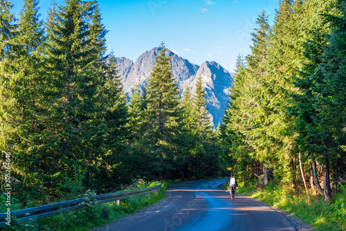 asphalted road to the Morskoye Oko lake in the Tatra mountains and a tourist
