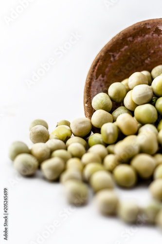 Dried fresh green pea in a clay bowl ioslated on white.; photo