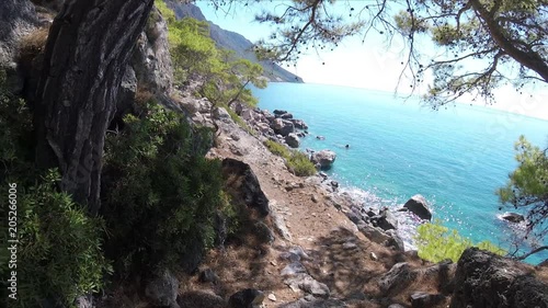 Walking with GoPro Camera on a rocky Path along the Sea Shore of Crete island