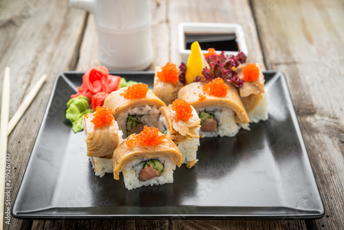 Rainbow Sushi Roll with salmon, eel, tuna, avocado, royal prawn, cream cheese Philadelphia, caviar tobica, chuka. Sushi menu. Japanese food. photo